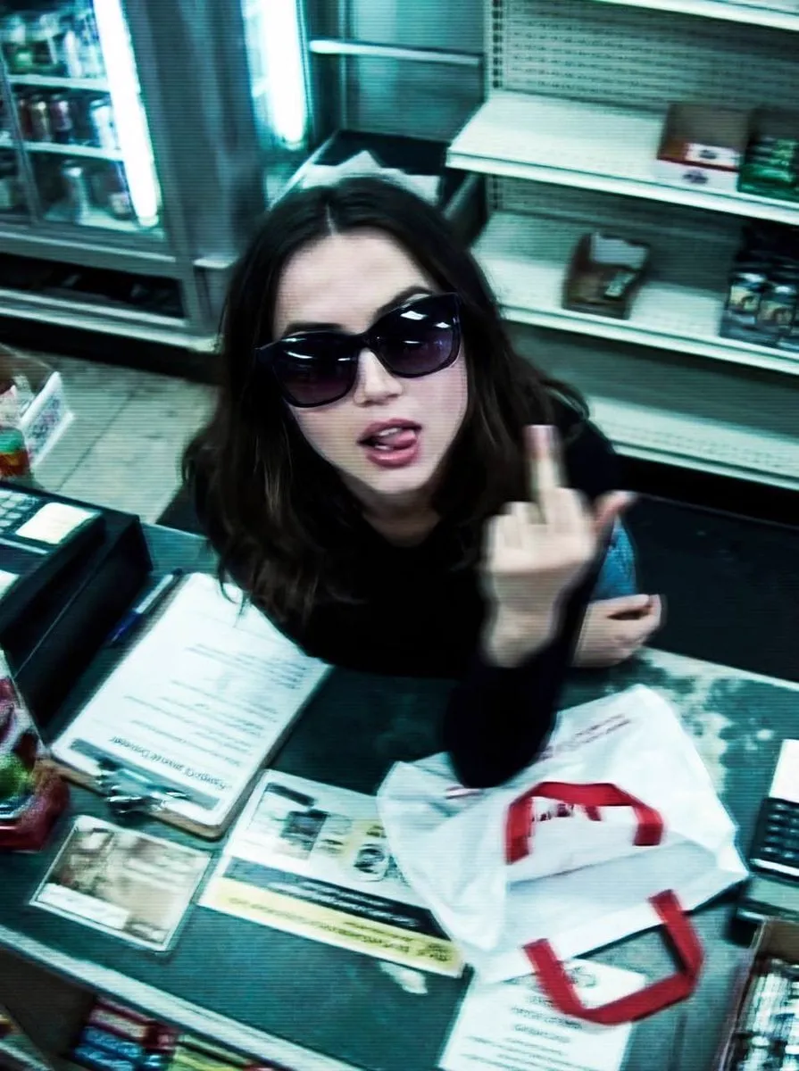 { "image_description": { "title": "Surveillance Feed: Defiant Subject in Retail… — 2/4