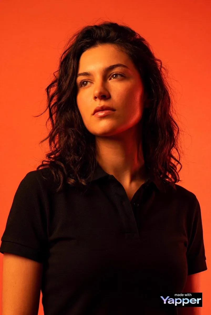 Create a high-impact editorial studio portrait using the person from the…
