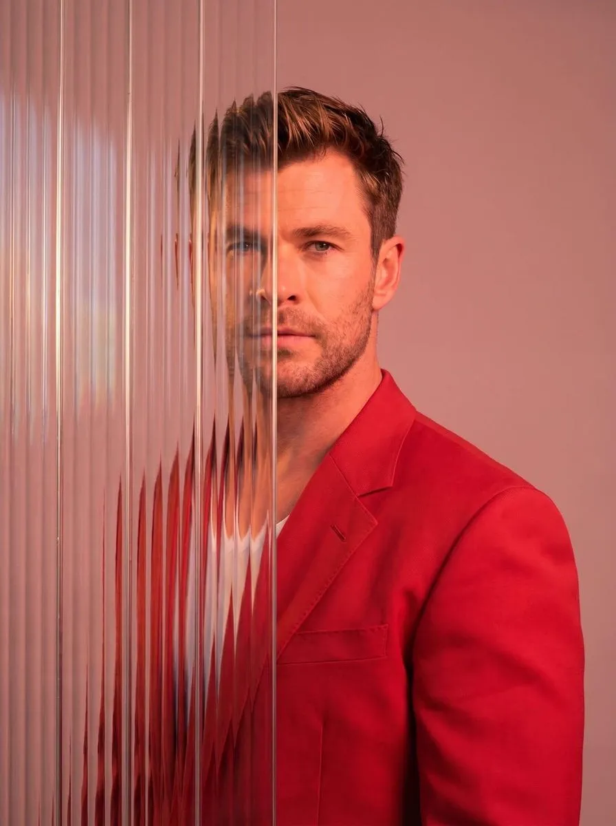 A striking editorial portrait photograph of a person wearing a red blazer, shot… — 1/2