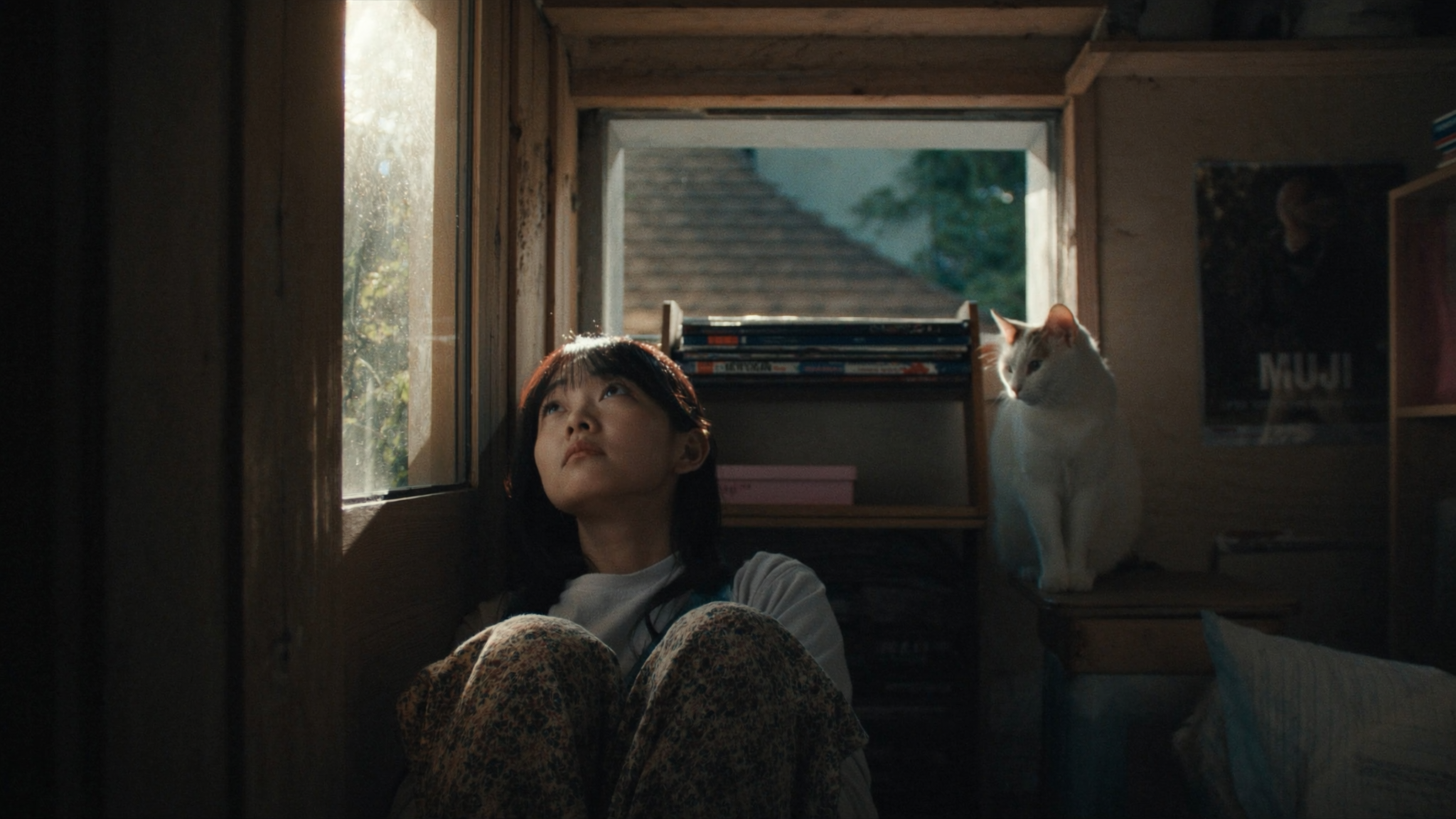 {"Caption": "A quiet, intimate moment: a young woman sits on the floor by an old...