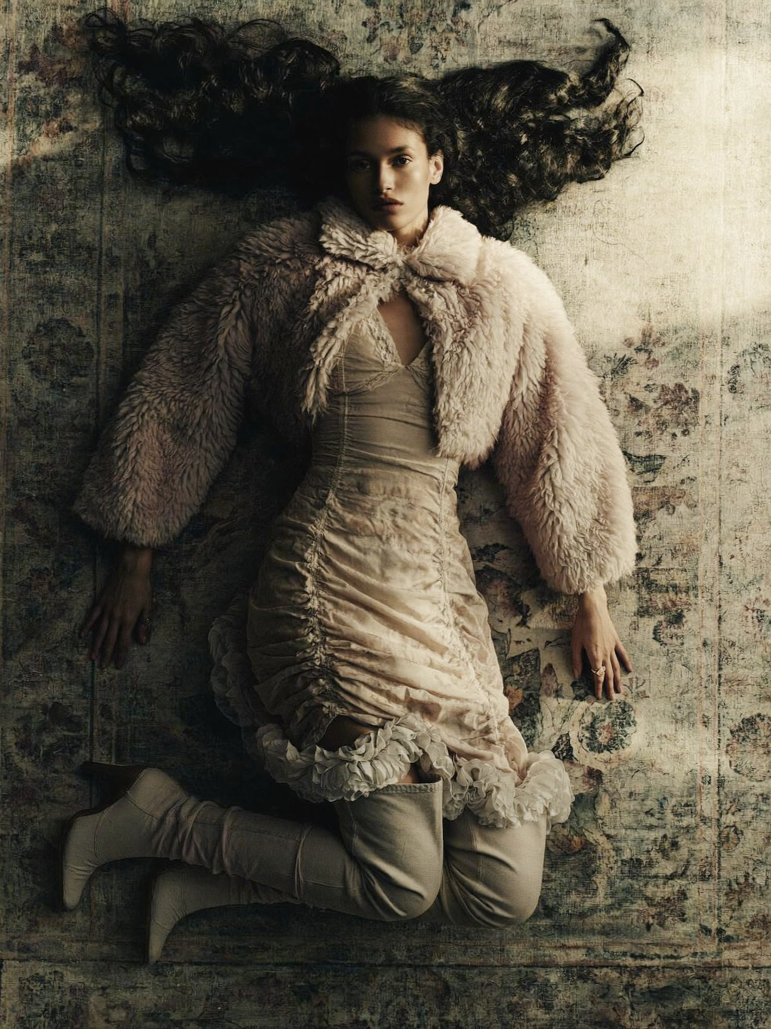 A high-angle, full-body fashion editorial photograph of a young adult South Asian...