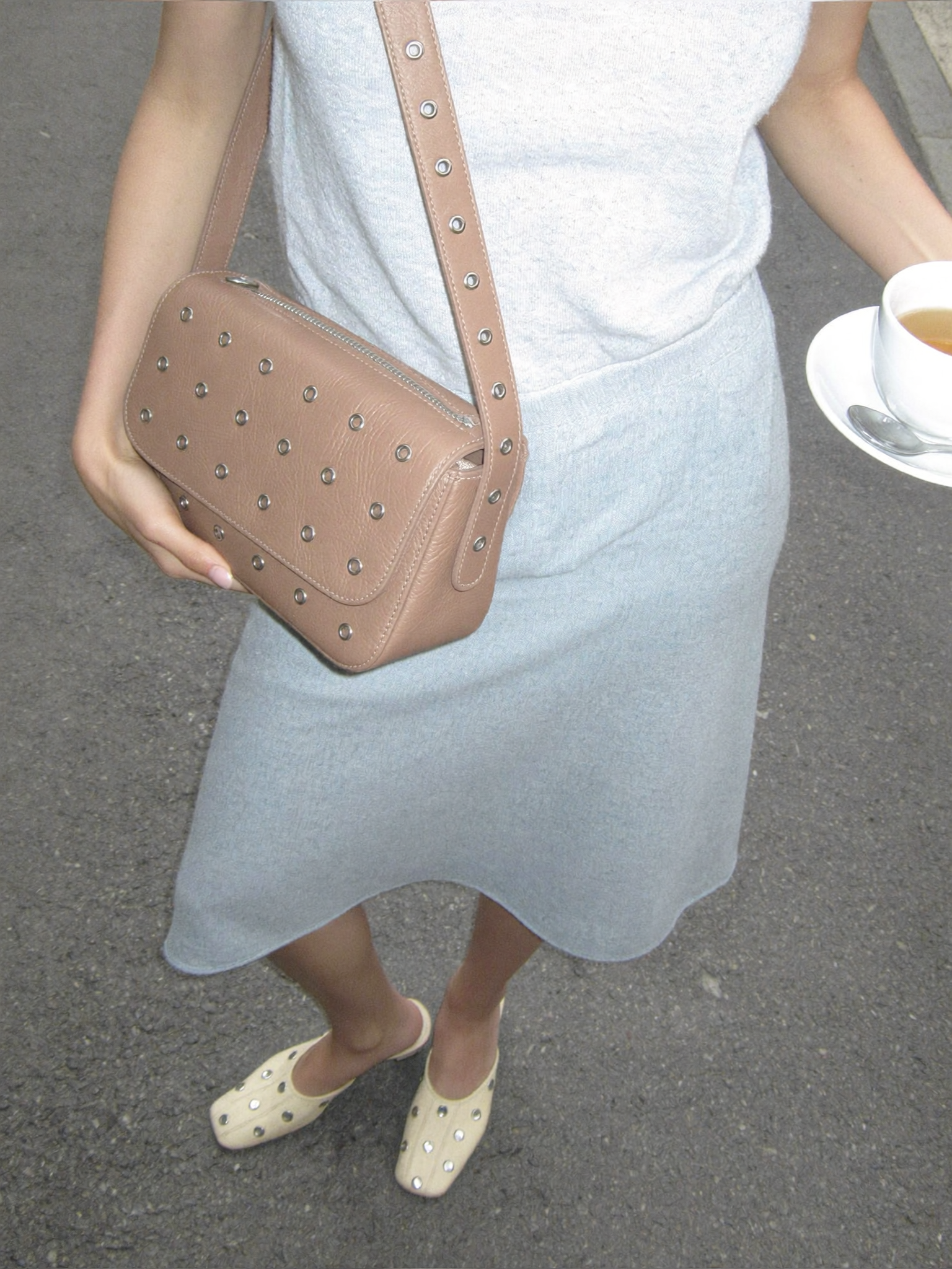 Close-up overhead shot of a young woman, showing only the lower half of her body
